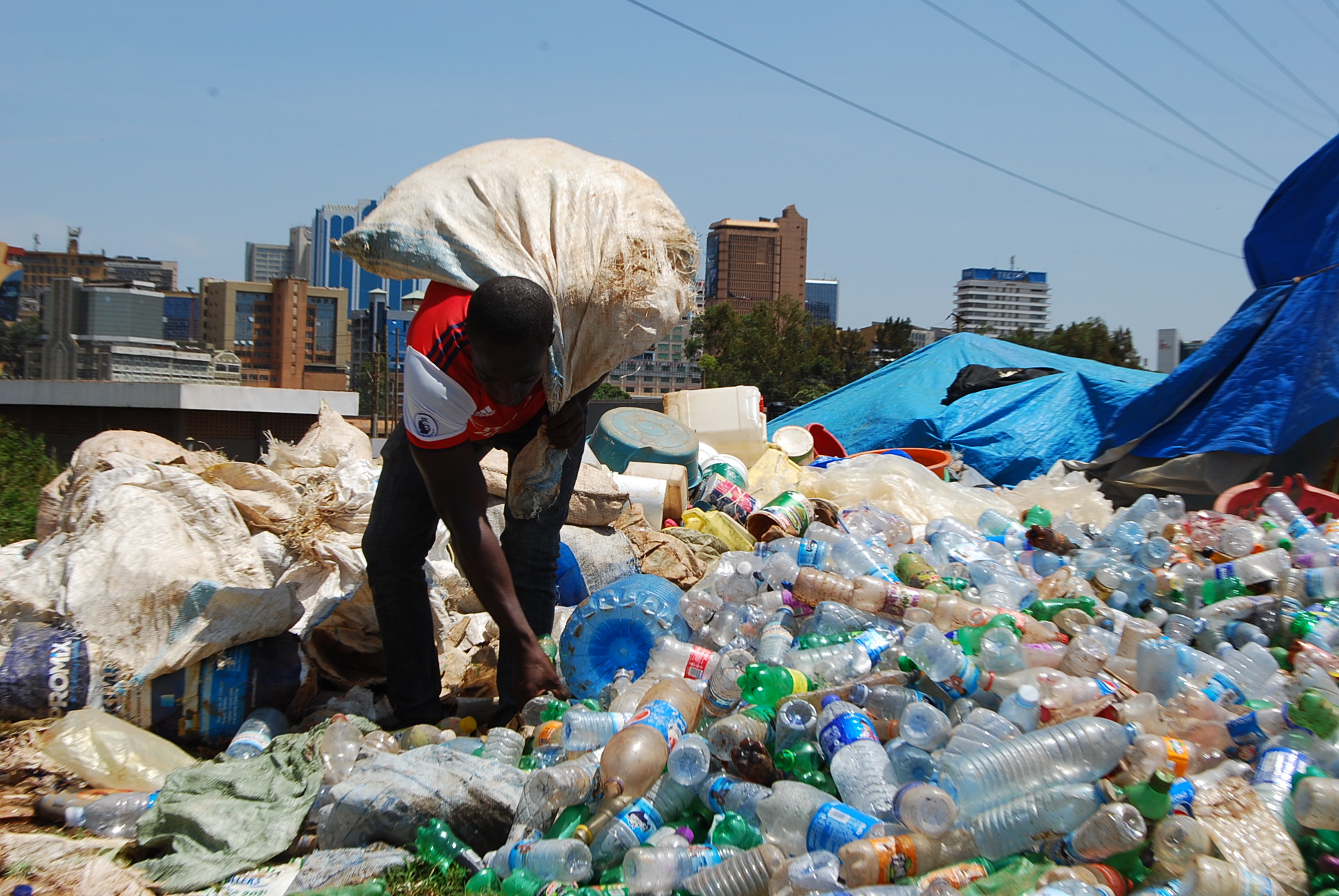 A-man-rummaging-through-a-dumpsite-replete-with-plastic-waste-in-Kampala-picture-credit-End-Plastic-Pollution-FB-PAGE